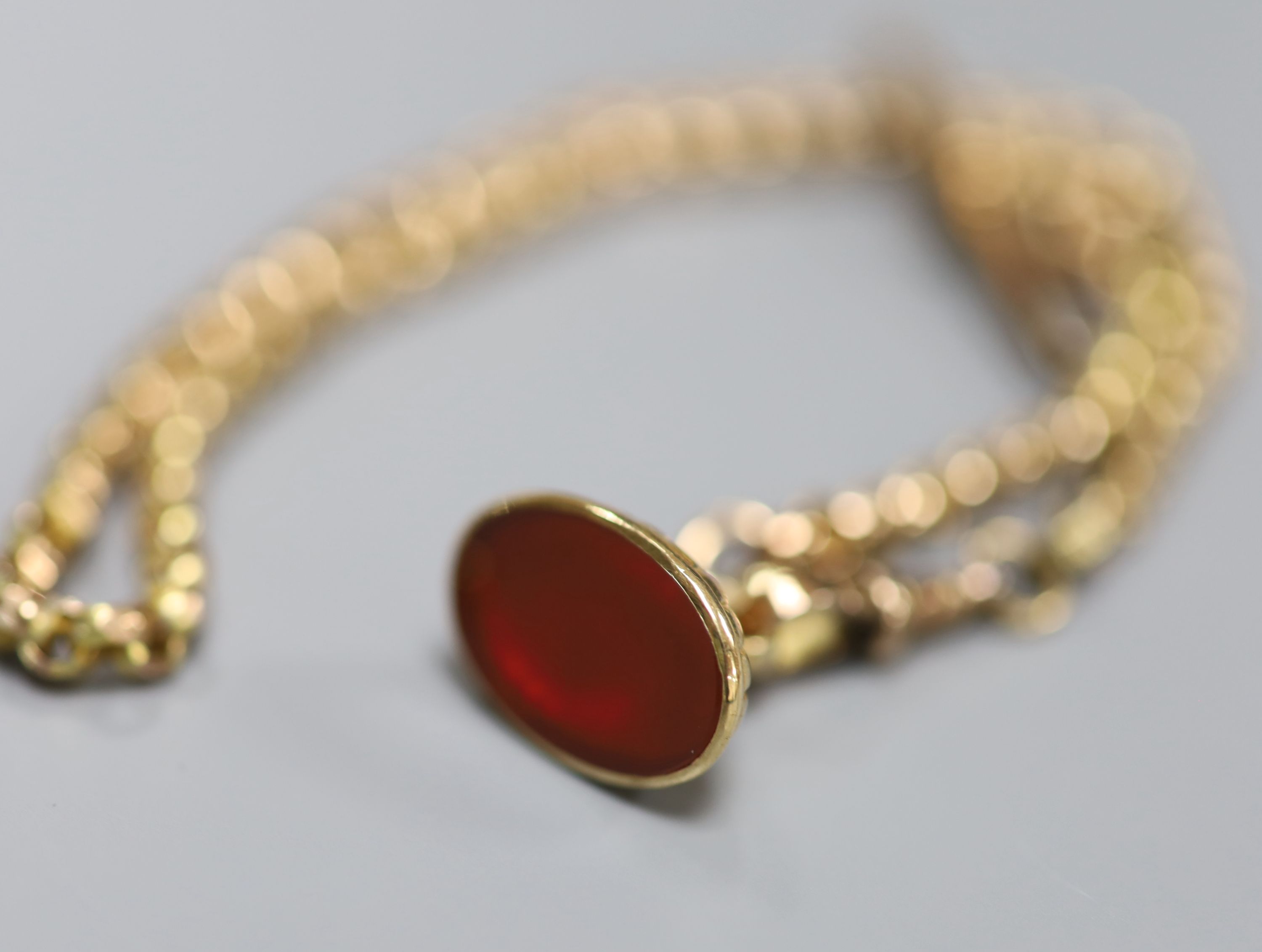 A late Victorian yellow metal (stamped 9c) albert chain, hung with a modern 9ct gold and carnelian? set fob seal, 36cm.